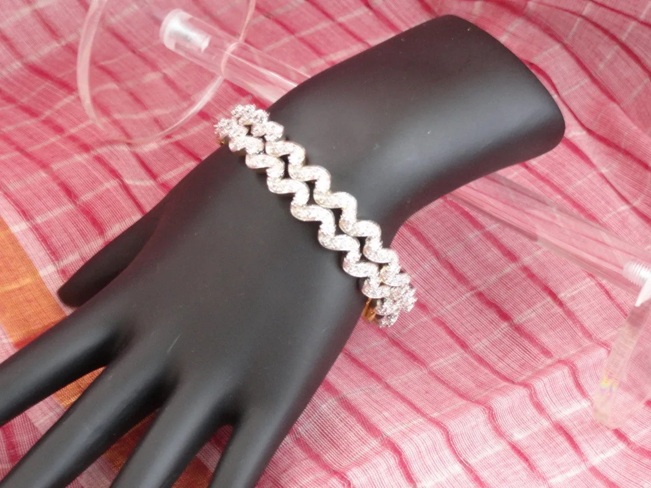 "Ripples"- Gold covered brass white stone bangles. White stone statement bangle bracelets from India.  From Artikrti.