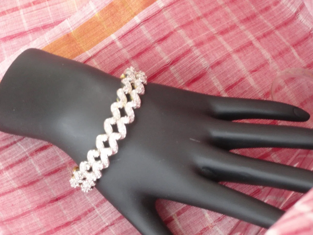 "Ripples"- Gold covered brass white stone bangles. White stone statement bangle bracelets from India.  From Artikrti.