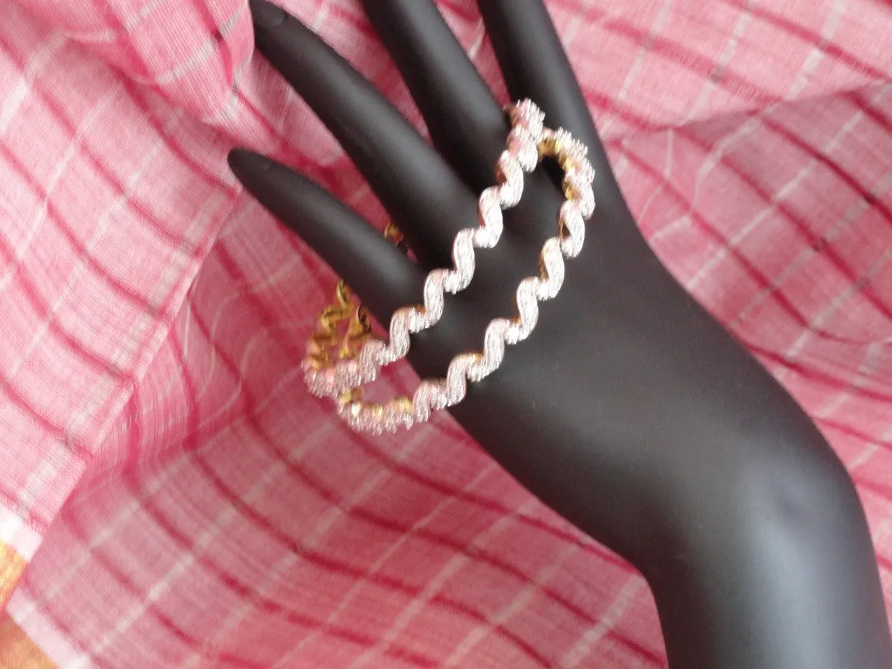 "Ripples"- Gold covered brass white stone bangles. White stone statement bangle bracelets from India.  From Artikrti.