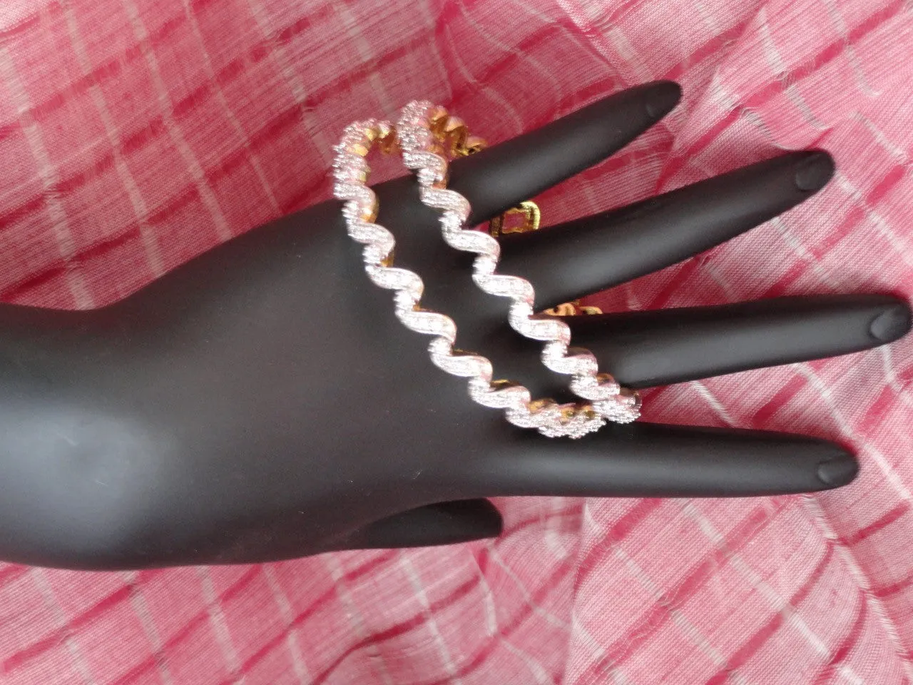 "Ripples"- Gold covered brass white stone bangles. White stone statement bangle bracelets from India.  From Artikrti.