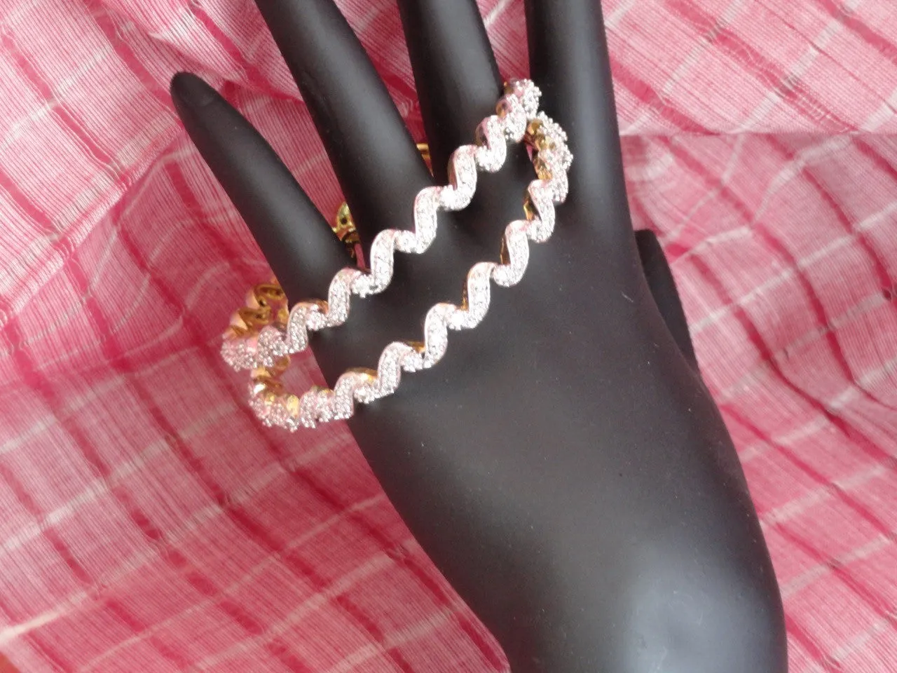 "Ripples"- Gold covered brass white stone bangles. White stone statement bangle bracelets from India.  From Artikrti.