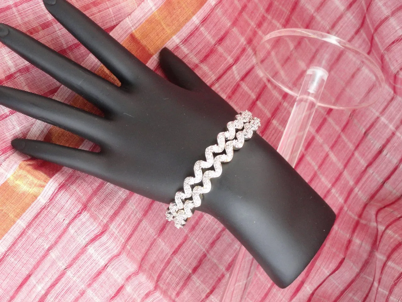 "Ripples"- Gold covered brass white stone bangles. White stone statement bangle bracelets from India.  From Artikrti.